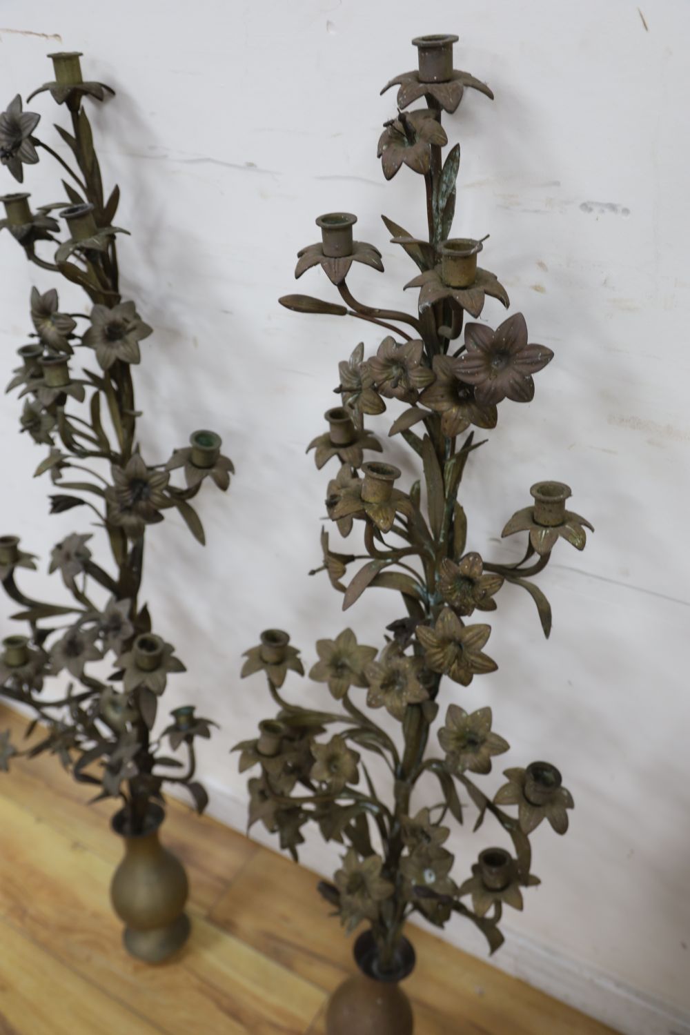 A pair of tall brass candelabra